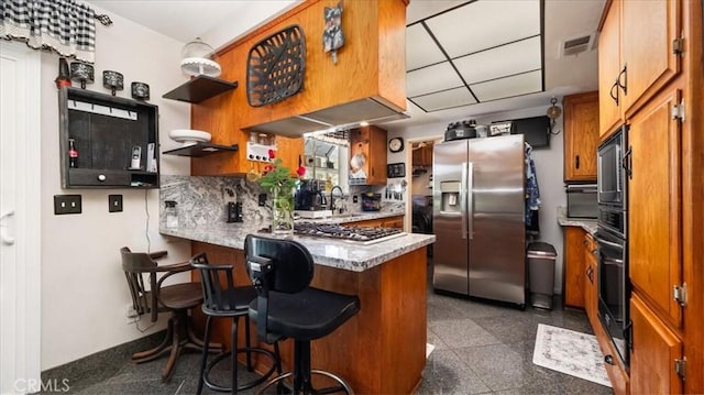 8356 Bella Vista Dr, Rancho Cucamonga, CA 91701 - kitchen with appliances with stainless steel finishes, brown cabinetry, open shelves, a peninsula, and a kitchen breakfast bar