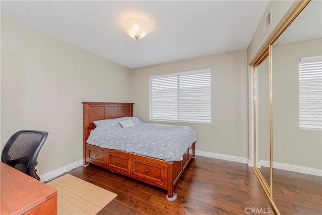 6242 E Inverness Pl, Orange, CA 92869 - bedroom with dark wood-type flooring, multiple windows, an office area, and a closet