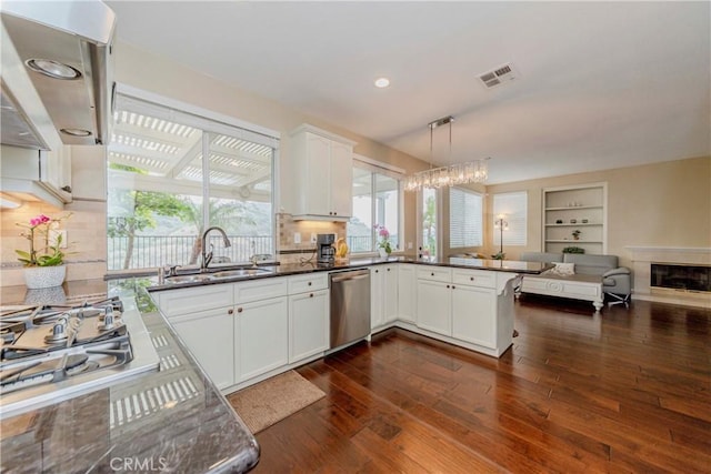 6242 E Inverness Pl, Orange, CA 92869 - kitchen featuring stainless steel appliances, range hood, dark wood-type flooring, open floor plan, and white cabinets