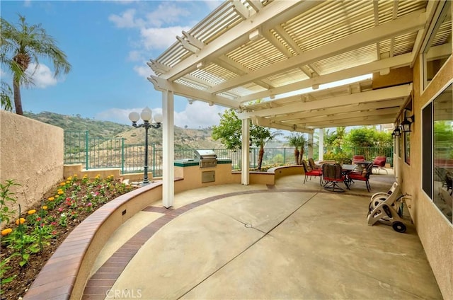 6242 E Inverness Pl, Orange, CA 92869 - fenced backyard featuring area for grilling, a pergola, a patio area, outdoor dining space, and a mountain view