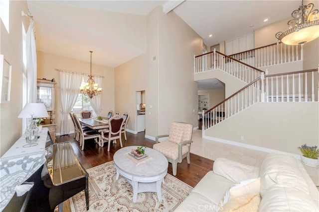 6242 E Inverness Pl, Orange, CA 92869 - living area with a chandelier, wood finished floors, stairs, and high vaulted ceiling