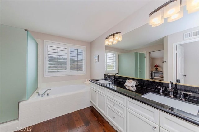 6242 E Inverness Pl, Orange, CA 92869 - full bath featuring double vanity, wood-type flooring, a garden tub, and a chandelier