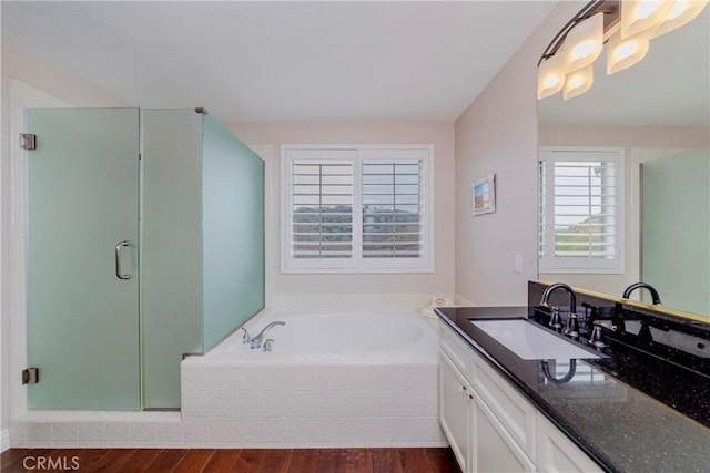 6242 E Inverness Pl, Orange, CA 92869 - full bathroom with wood finished floors, vanity, a bath, and a stall shower