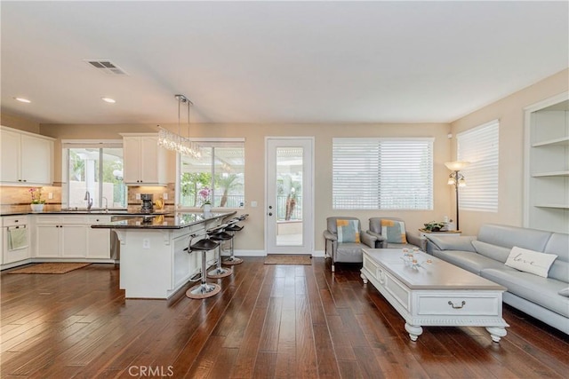 6242 E Inverness Pl, Orange, CA 92869 - living area with dark wood-style flooring and recessed lighting