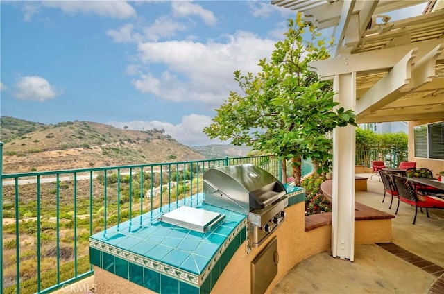 6242 E Inverness Pl, Orange, CA 92869 - view of patio with a mountain view and an outdoor kitchen