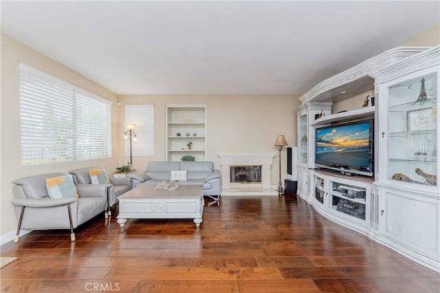 6242 E Inverness Pl, Orange, CA 92869 - living area with wood finished floors, a glass covered fireplace, and built in features
