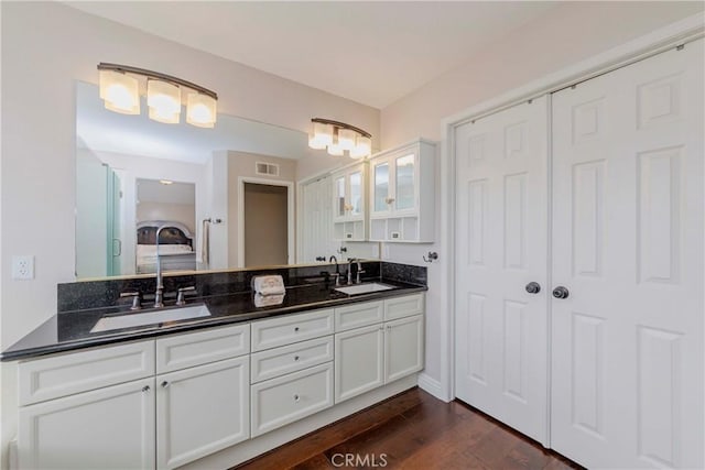 6242 E Inverness Pl, Orange, CA 92869 - bathroom with double vanity, wood finished floors, and ensuite bath