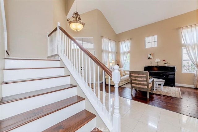 6242 E Inverness Pl, Orange, CA 92869 - stairs featuring high vaulted ceiling and wood finished floors