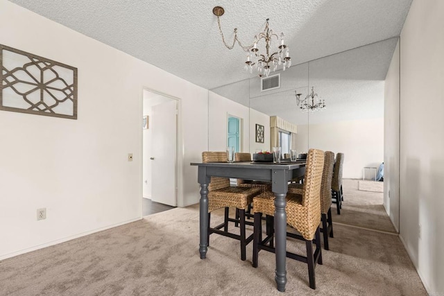 16566 Caminito Vecinos Unit 31, San Diego, CA 92128 - dining room featuring a chandelier, carpet floors, and a textured ceiling