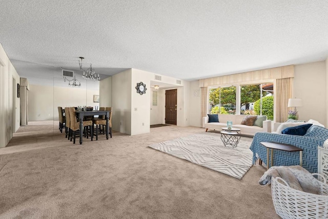16566 Caminito Vecinos Unit 31, San Diego, CA 92128 - carpeted living room with a chandelier and a textured ceiling
