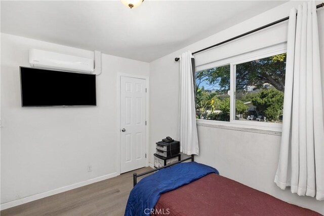 4657 Chateau Pl, San Diego, CA 92117 - bedroom with a wall mounted AC and wood finished floors