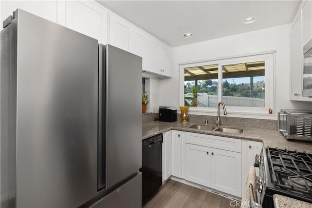 4657 Chateau Pl, San Diego, CA 92117 - kitchen with stainless steel appliances, white cabinetry, wood finished floors, light stone countertops, and recessed lighting