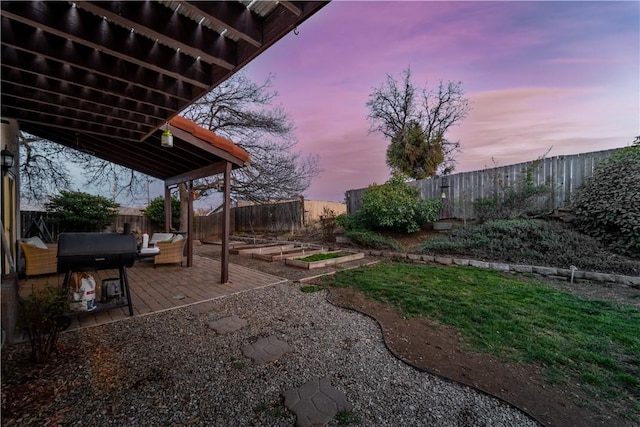 21304 Carriage Dr, Tehachapi, CA 93561 - yard at dusk featuring a garden, a patio, and a fenced backyard
