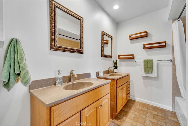 21304 Carriage Dr, Tehachapi, CA 93561 - full bathroom with two vanities, shower / bathtub combination with curtain, recessed lighting, and stone finish floors