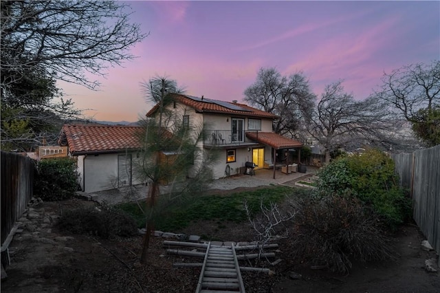 21304 Carriage Dr, Tehachapi, CA 93561 - rear view of house with solar panels, a fenced backyard, a tile roof, a patio, and stucco siding