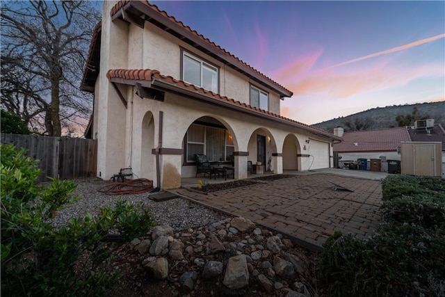 21304 Carriage Dr, Tehachapi, CA 93561 - back of property with driveway, a tile roof, an attached garage, and stucco siding