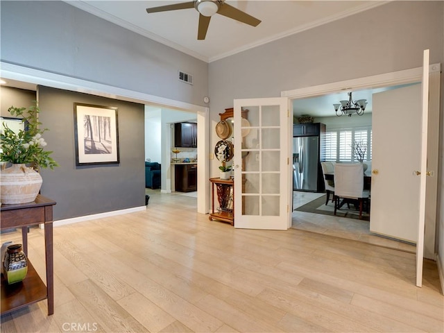 21829 Legend Ave, Carson, CA 90745 - interior space featuring a chandelier, ceiling fan, light wood-style floors, and crown molding