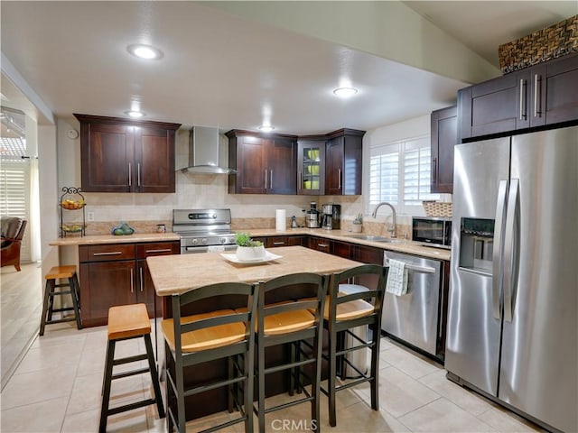 21829 Legend Ave, Carson, CA 90745 - kitchen featuring stainless steel appliances, wall chimney range hood, decorative backsplash, dark brown cabinets, and light tile patterned floors