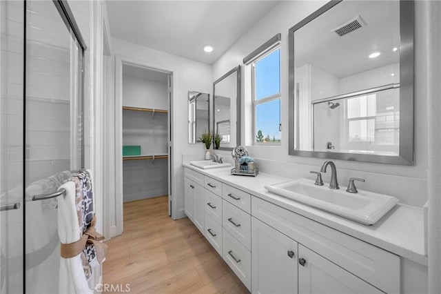 18309 Goldbark Way, Yorba Linda, CA 92886 - full bathroom featuring double vanity, a shower stall, a walk in closet, wood finished floors, and recessed lighting