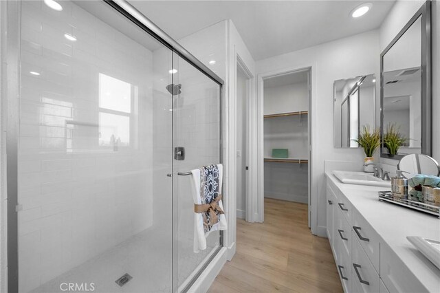 18309 Goldbark Way, Yorba Linda, CA 92886 - full bathroom with a shower stall, double vanity, wood finished floors, and a spacious closet