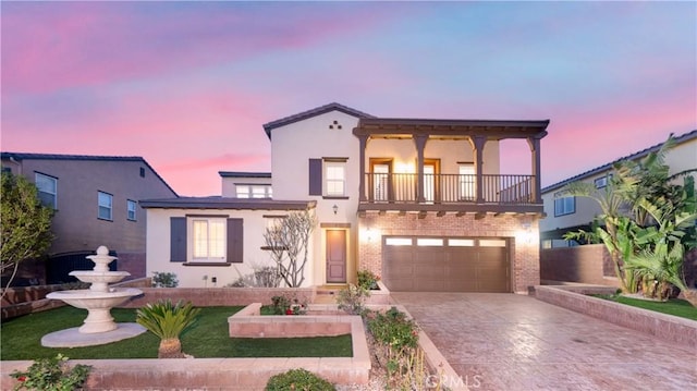 15448 Six M Ranch Ln, Fontana, CA 92336 - mediterranean / spanish-style home with a balcony, driveway, stucco siding, a garage, and brick siding