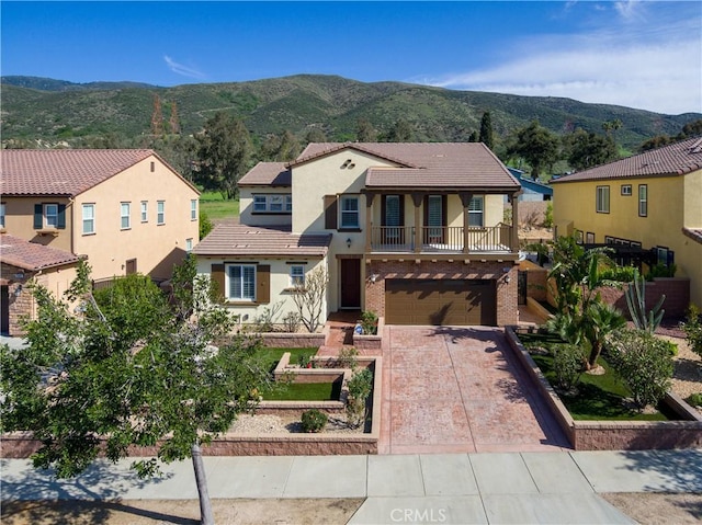 15448 Six M Ranch Ln, Fontana, CA 92336 - mediterranean / spanish home with a balcony, stucco siding, driveway, a tiled roof, and a mountain view