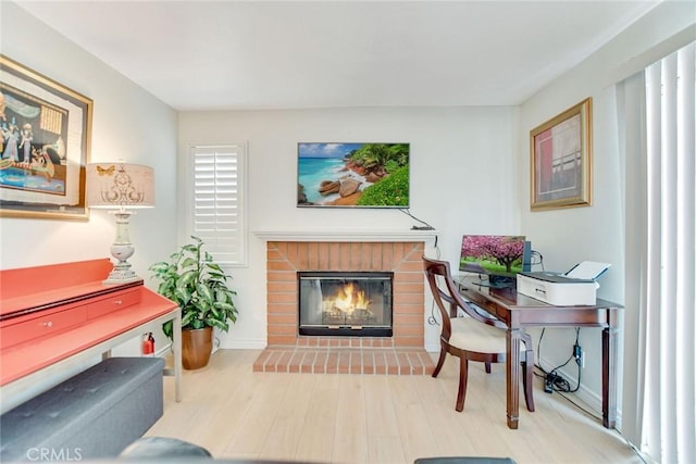 5575 Osborne Ct, San Bernardino, CA 92407 - office area with a brick fireplace and wood finished floors