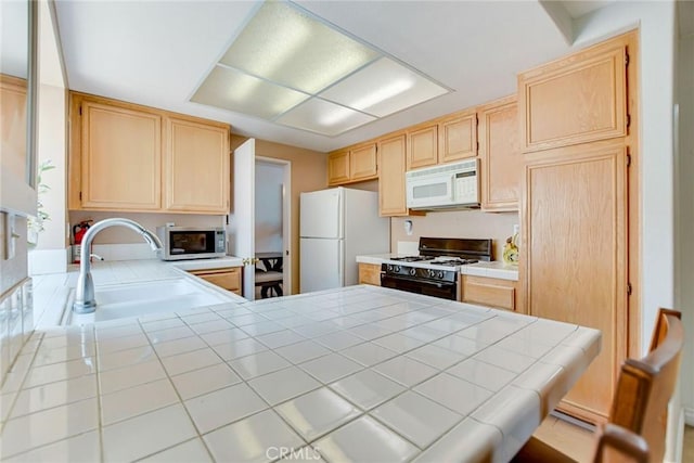 5575 Osborne Ct, San Bernardino, CA 92407 - kitchen with white appliances, light brown cabinets, tile counters, and a peninsula