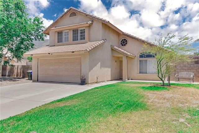 5575 Osborne Ct, San Bernardino, CA 92407 - mediterranean / spanish house featuring stucco siding, an attached garage, a tiled roof, and concrete driveway