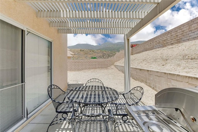 5575 Osborne Ct, San Bernardino, CA 92407 - fenced backyard with a mountain view, a patio area, a pergola, area for grilling, and outdoor dining space