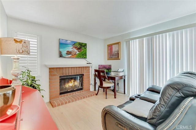 5575 Osborne Ct, San Bernardino, CA 92407 - living room featuring wood finished floors and a brick fireplace
