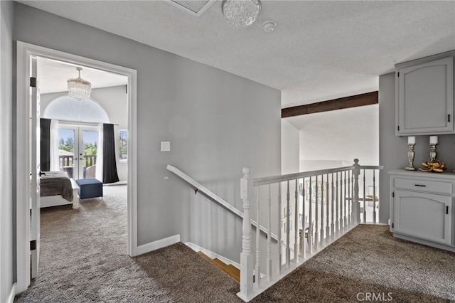 7209 Copper Creek Way, Bakersfield, CA 93308 - corridor with dark colored carpet, an upstairs landing, french doors, and a textured ceiling