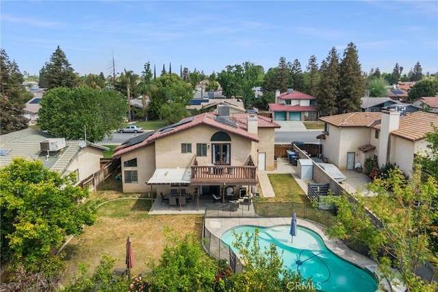 7209 Copper Creek Way, Bakersfield, CA 93308 - back of house with a fenced backyard, roof mounted solar panels, and stucco siding