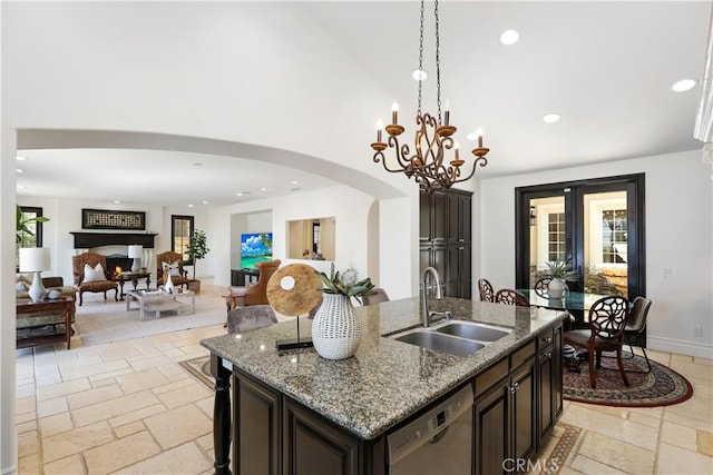 41 Balcony, Irvine, CA 92603 - kitchen featuring dishwasher, stone tile floors, arched walkways, pendant lighting, and a high ceiling