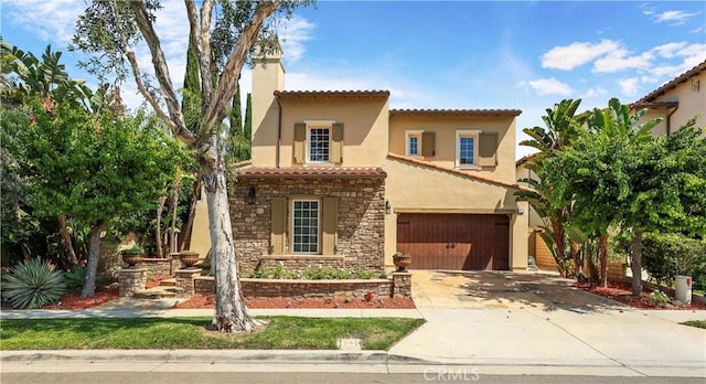 41 Balcony, Irvine, CA 92603 - mediterranean / spanish house with a tiled roof, driveway, stone siding, a chimney, and stucco siding