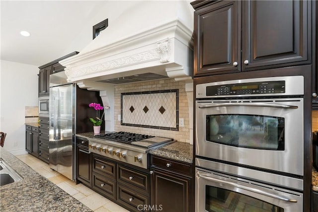 41 Balcony, Irvine, CA 92603 - kitchen featuring stainless steel appliances, decorative backsplash, dark brown cabinets, premium range hood, and recessed lighting