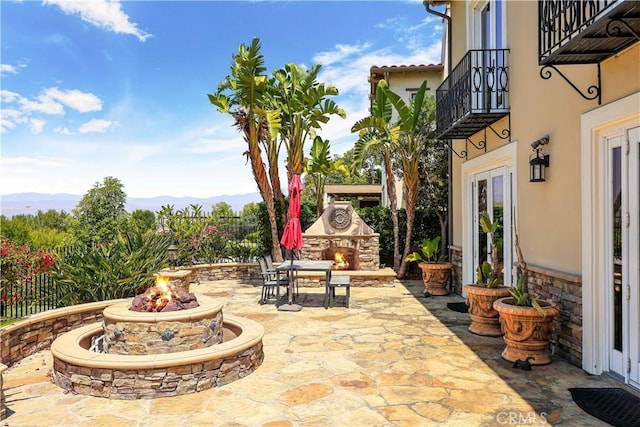 41 Balcony, Irvine, CA 92603 - patio / terrace with an outdoor stone fireplace, a patio, and a fire pit