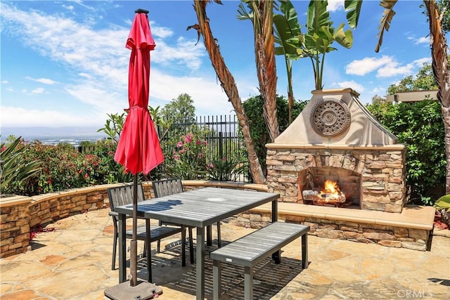41 Balcony, Irvine, CA 92603 - view of patio with an outdoor stone fireplace and outdoor dining space