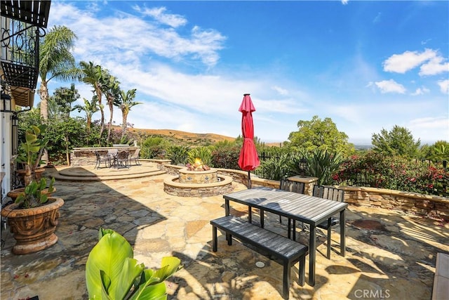 41 Balcony, Irvine, CA 92603 - view of patio featuring outdoor dining space and a fire pit
