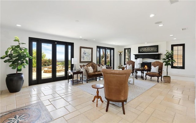 41 Balcony, Irvine, CA 92603 - living area with recessed lighting, french doors, a warm lit fireplace, and stone tile floors
