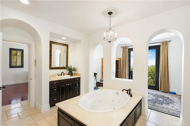 41 Balcony, Irvine, CA 92603 - full bathroom with vanity, a tub with jets, recessed lighting, and stone tile floors