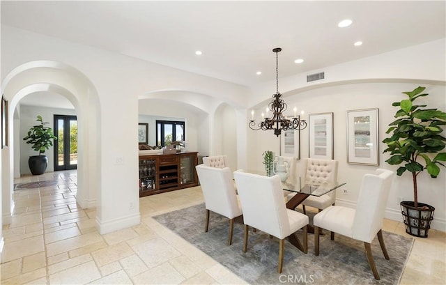 41 Balcony, Irvine, CA 92603 - dining space with recessed lighting, healthy amount of natural light, a chandelier, stone tile flooring, and arched walkways