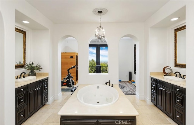 41 Balcony, Irvine, CA 92603 - bathroom featuring two vanities, a tub with jets, recessed lighting, french doors, and a chandelier