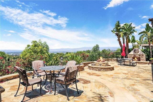 41 Balcony, Irvine, CA 92603 - view of patio / terrace featuring an outdoor stone fireplace, a fire pit, and outdoor dining area