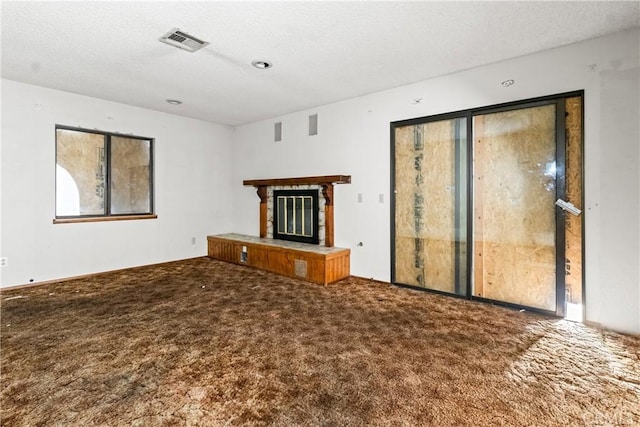 42865 Normandy Ln, Lancaster, CA 93536 - unfurnished living room with carpet flooring, a glass covered fireplace, and a textured ceiling