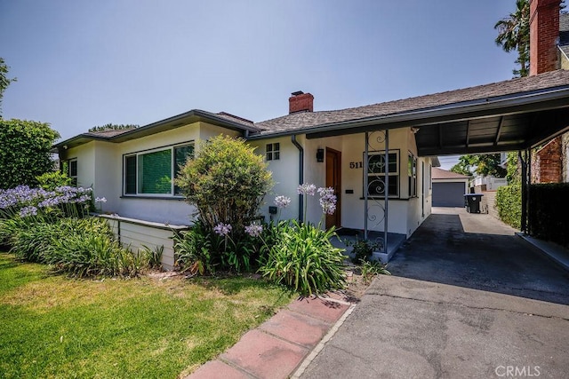 511 Delaware Rd, Burbank, CA 91504 - ranch-style home featuring a chimney, driveway, an outdoor structure, a front yard, and stucco siding