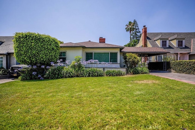 511 Delaware Rd, Burbank, CA 91504 - view of front of house featuring a front lawn, an attached carport, driveway, and stucco siding