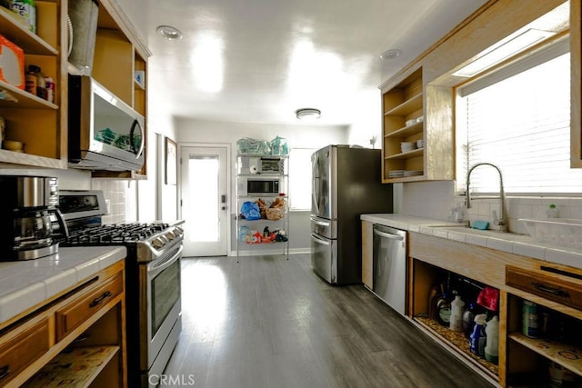 511 Delaware Rd, Burbank, CA 91504 - kitchen with open shelves, appliances with stainless steel finishes, tile counters, and decorative backsplash