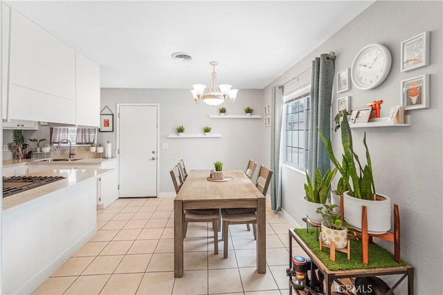 14020 Orizaba Ave Unit 6A, Paramount, CA 90723 - dining room with a chandelier and light tile patterned flooring