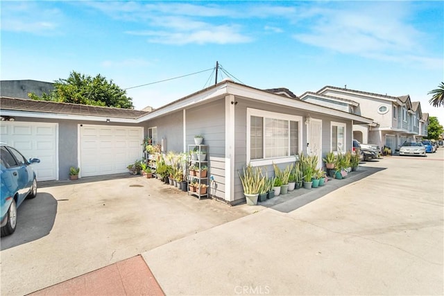 14020 Orizaba Ave Unit 6A, Paramount, CA 90723 - view of home's exterior featuring driveway and an attached garage